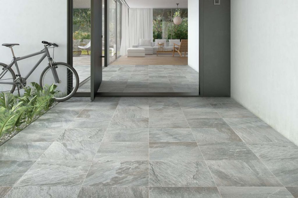 Outdoor grey stone effect tiles with bike.